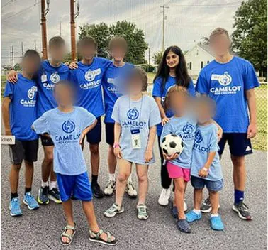 Camelot for Children volunteers and campers outdoors