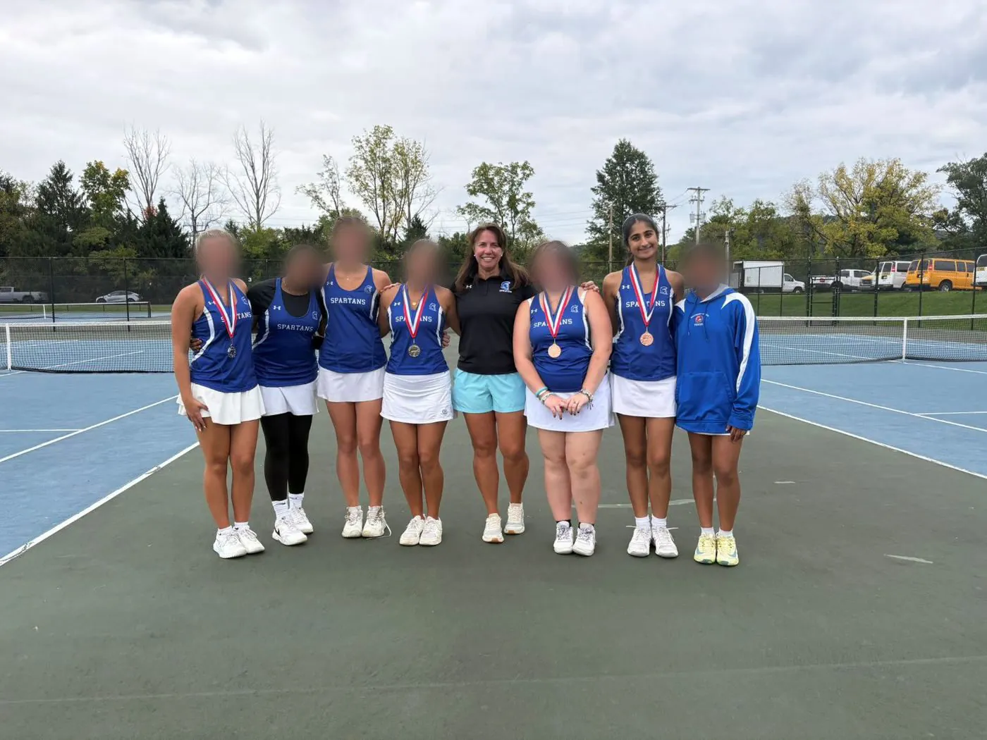 Southern Lehigh girls tennis team with medals on the court